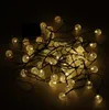 A tangled string of solar-powered garden lights with clear, textured bulbs. Náhľad obrázku produktu