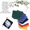 A collection of colorful mesh filter bags arranged in a fanned-out pattern, with a black bag containing some papers and a blue-bordered transparent sheet in the foreground. A decorative vine with pink flowers is draped across the top. Produktbild-Vorschau