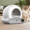 A modern, automated cat litter box is shown in a home environment with a cat sitting next to it. Podgląd zdjęcia produktu