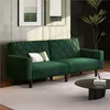 A green velvet sofa with a diamond tufted back and a decorative pillow is shown in a modern living room setting. Produktbild-Vorschau