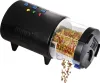 A black automatic fish feeder with fish food dispensing. Produktbild-Vorschau