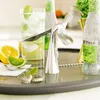A bar setup with drinks, citrus fruits, and a bottle opener. Podgląd zdjęcia produktu