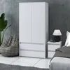A bedroom scene featuring a white wardrobe and a bedside table with a lamp. Produktbild-Vorschau