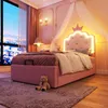 A child's bedroom at night, featuring a pink bed with a crown headboard and LED lights. Produktbild-Vorschau