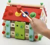 A hand is shown using a hammer to hit a ball into a hole on a wooden toy house. Náhľad obrázku produktu