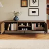 A wooden TV stand with various items on and inside it, placed on a wooden floor with a rug in front. Anteprima dell’immagine prodotto