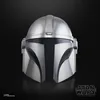 A close-up studio shot of a silver Mandalorian helmet against a black background. Voir les images du produit