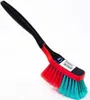 A cleaning brush with a black handle and red and turquoise bristles, set against a white background. Produktbild-Vorschau