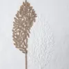 A close-up of an embroidered curtain with a leaf design. Produktbild-Vorschau