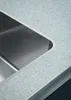 A close-up view of a stainless steel sink integrated into a speckled countertop. Produktbild-Vorschau
