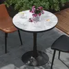 A round marble-patterned table with two chairs and two cups of coffee on a patio. Anteprima dell’immagine prodotto