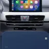 A close-up view of a car's dashboard, focusing on the infotainment screen and air vents, with a blue overlay at the bottom. Produktbild-Vorschau