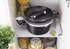 Kitchen cabinet shelf with cookware and food items. Voir les images du produit