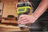 A person is using a Ryobi cordless router to shape the edge of a wooden plank in a workshop setting. Anteprima dell’immagine prodotto