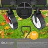 Close-up of a foldable wagon's wheels and handle on a grassy lawn with fallen leaves. Produktbild-Vorschau