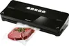 A black vacuum sealer with a piece of raw meat in a plastic bag in front of it. Produktbild-Vorschau
