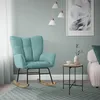 A teal rocking chair in a living room setting with a small side table and a framed picture on the wall. Produktbild-Vorschau