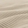 A close-up view of beige corduroy fabric, showing the texture and the wavy pattern of the material. Produktbild-Vorschau