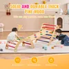 Two young children playing on a wooden climbing structure indoors. Voir les images du produit