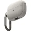 A close-up, angled view of a light gray protective case for wireless earbuds, attached to a dark gray carabiner clip. Produktbild-Vorschau