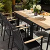 An outdoor dining set with a table and chairs on a patio. Produktbild-Vorschau