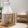 A nursery room setting with a crib and changing table. Produktbild-Vorschau