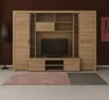 A living room scene with a large wooden entertainment center, a TV, and two rugs. Produktbild-Vorschau