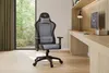 A gaming chair is placed in a modern home office setting next to a desk with a computer. Náhľad obrázku produktu
