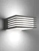 A modern, rectangular wall light fixture with horizontal slats, mounted on a wall. Produktbild-Vorschau