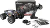 A remote-controlled monster truck, its controller, and accessories are displayed on a white background, with the product's packaging in the background. Anteprima dell’immagine prodotto