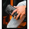 A person is holding a black phone case with a kickstand. Náhled obrázku produktu