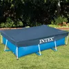 A rectangular Intex swimming pool covered with a dark blue tarp, set up on a grassy lawn with trees and bushes in the background. Produktbild-Vorschau