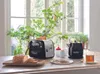 A breakfast scene with a toaster, kettle, bread, and tea. Voir les images du produit
