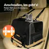 A cat is sitting in a pet carrier inside a car. Produktbild-Vorschau