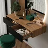 A vanity table with drawers and a mirror, decorated with makeup and plants. Produktbild-Vorschau