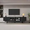 A modern black TV lowboard with a television mounted above it, set against a textured gray wall. Produktbild-Vorschau