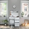 A white vanity table with a stool and mirror, set up in a room with two windows, a radiator, and decorative candles. Podgląd zdjęcia produktu