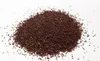 A pile of small, dark brown seeds on a white background. Produktbild-Vorschau