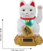 A white Maneki-neko (waving cat) solar-powered figurine with a gold coin and a red collar, sitting on a gold base. Dimensions are indicated by measurement lines. Produktbild-Vorschau