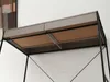 Close-up view of the underside of a desk with drawers and a metal frame. Voir les images du produit