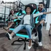 People are having fun sitting in gaming chairs in an office-like environment. Produktbild-Vorschau
