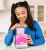 A young girl is playing with a toy toaster and a cookie-like toy. Anteprima dell’immagine prodotto