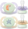 Two Philips Avent pacifiers are shown against a white background. One pacifier is purple and green with a moon design, and the other is tan and green with a star design. Náhľad obrázku produktu