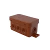 A brown electrical junction box with multiple circular entry points and a mounting bracket is shown against a white background. Podgląd zdjęcia produktu