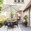 An outdoor patio scene with a dining set and umbrella. Produktbild-Vorschau