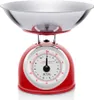 A red retro-style kitchen scale with a stainless steel bowl is shown against a white background. Náhľad obrázku produktu