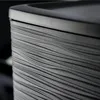 A close-up, detailed view of the textured side of a dark gray cabinet or drawer unit. Produktbild-Vorschau