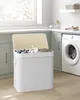 A laundry room with a washing machine and a laundry basket. Produktbild-Vorschau