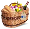 A wicker picnic basket filled with bread, tulips, and a bottle of wine, with a "Made in EU" tag attached. Náhled obrázku produktu