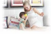 A woman and a child are playing on a bed with a toy. Voir les images du produit